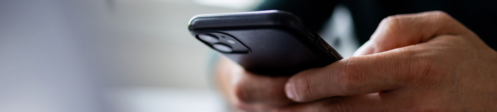 close-up of hands holding a smartphone